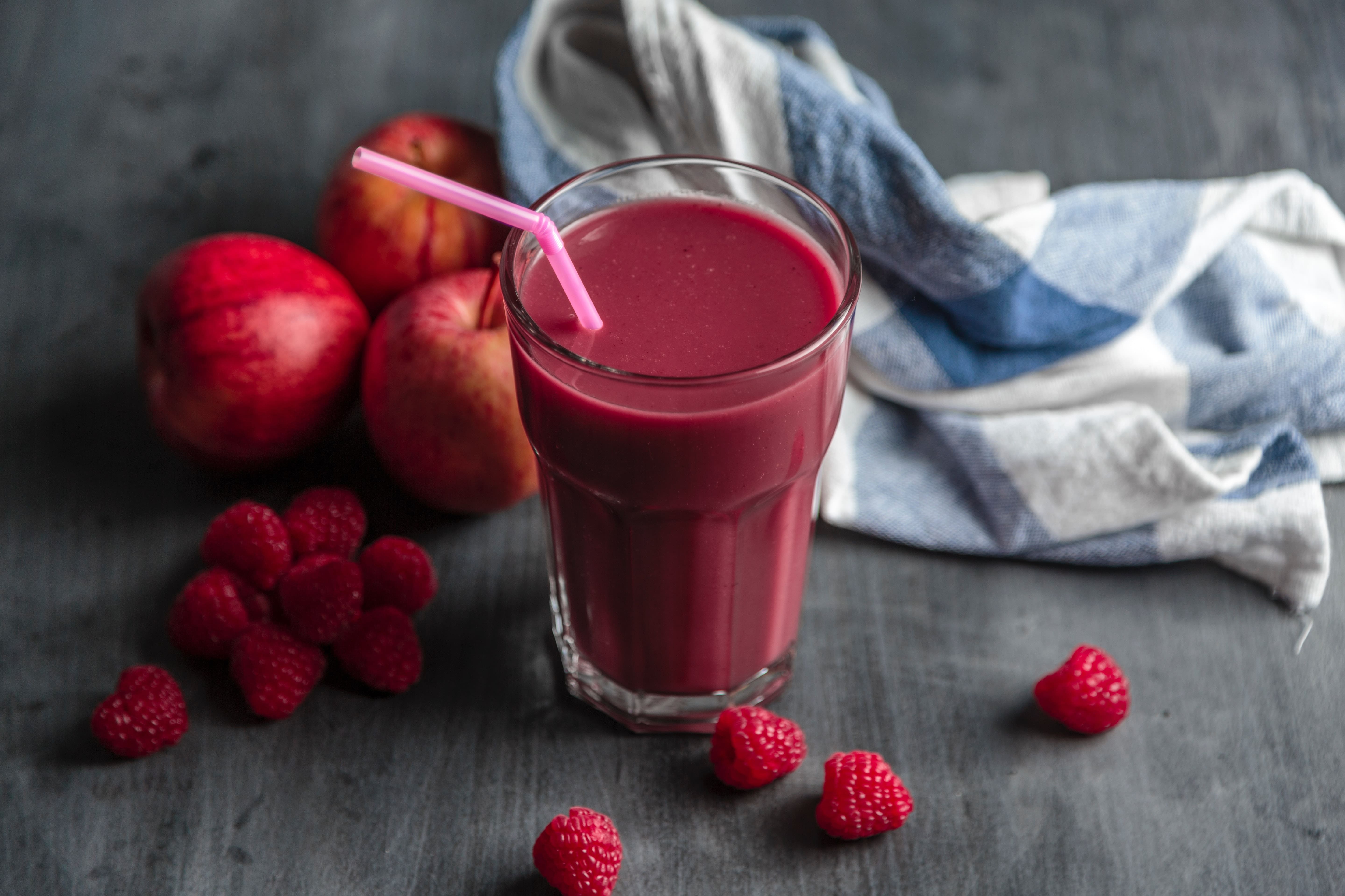A glass of red-orange coloured smoothie